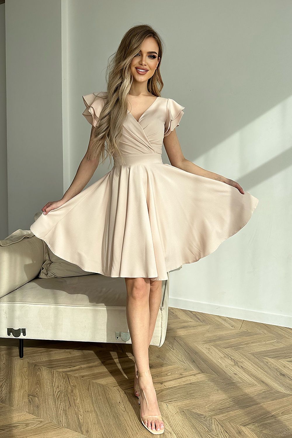 Vrouw in Ruffle Charm taillejurk met ruches aan de mouwen β elegante meisjesachtige jurk